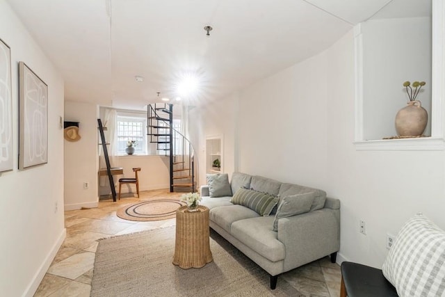 living room featuring stairs and baseboards