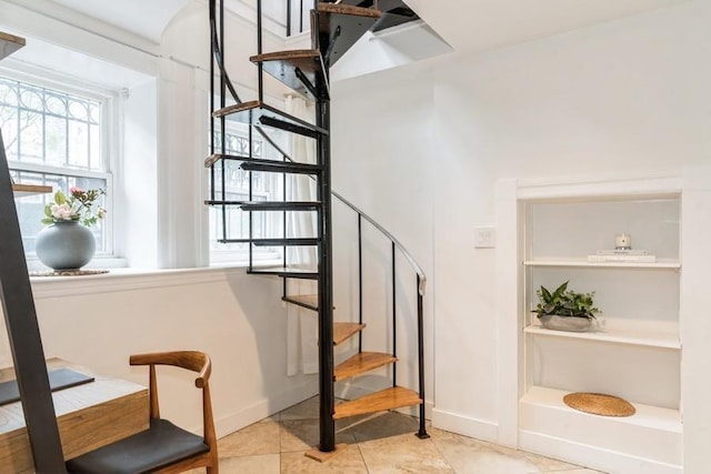 stairway featuring tile patterned floors and baseboards