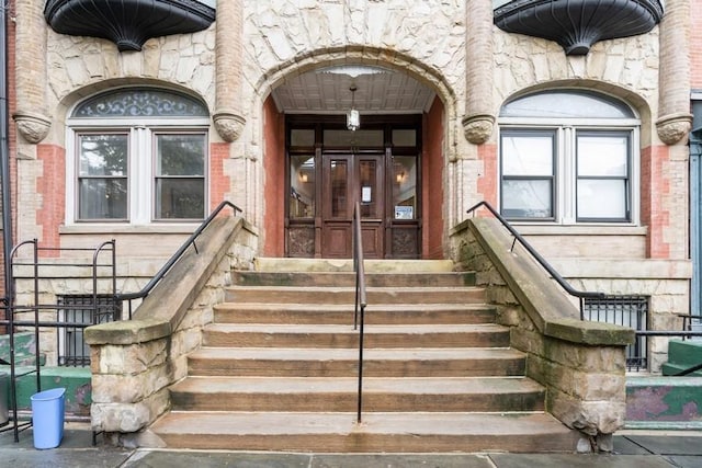 property entrance with stone siding