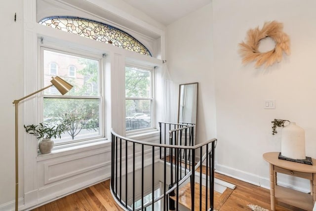 staircase with wood finished floors and baseboards