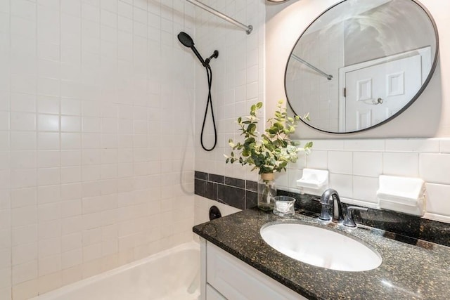bathroom featuring shower / bath combination, vanity, and backsplash