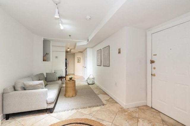 living room with baseboards and light tile patterned floors