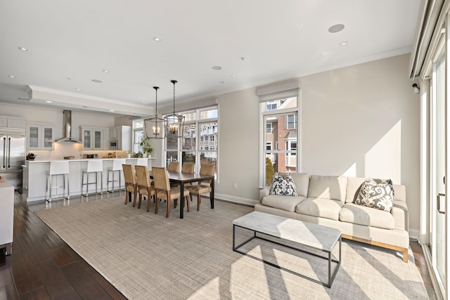 living area with recessed lighting, baseboards, ornamental molding, and dark wood finished floors