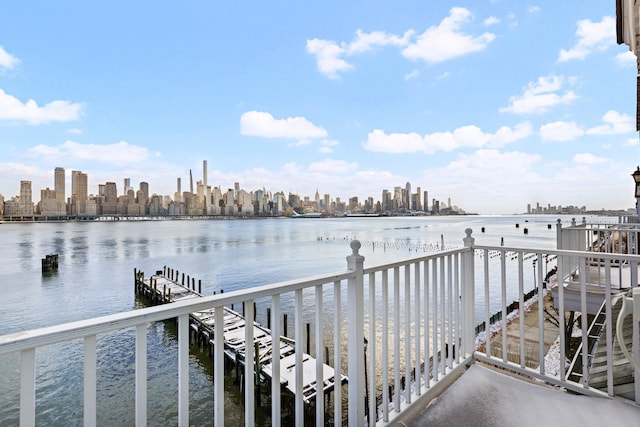 view of dock featuring a water view and a city view
