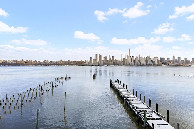 view of dock with a city view and a water view