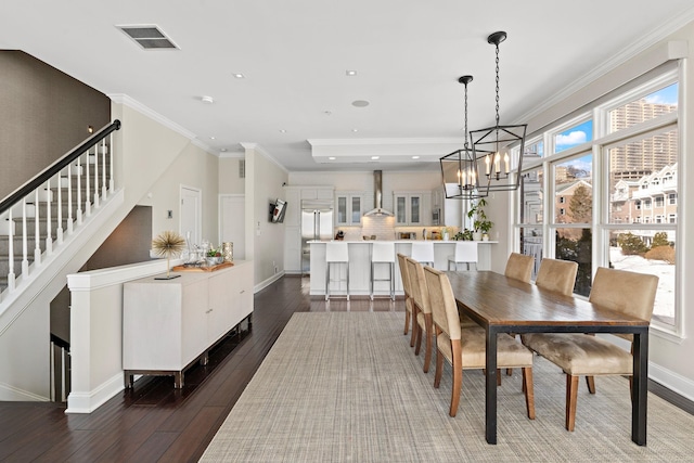 dining room with crown molding, baseboards, dark wood-style floors, stairway, and a notable chandelier