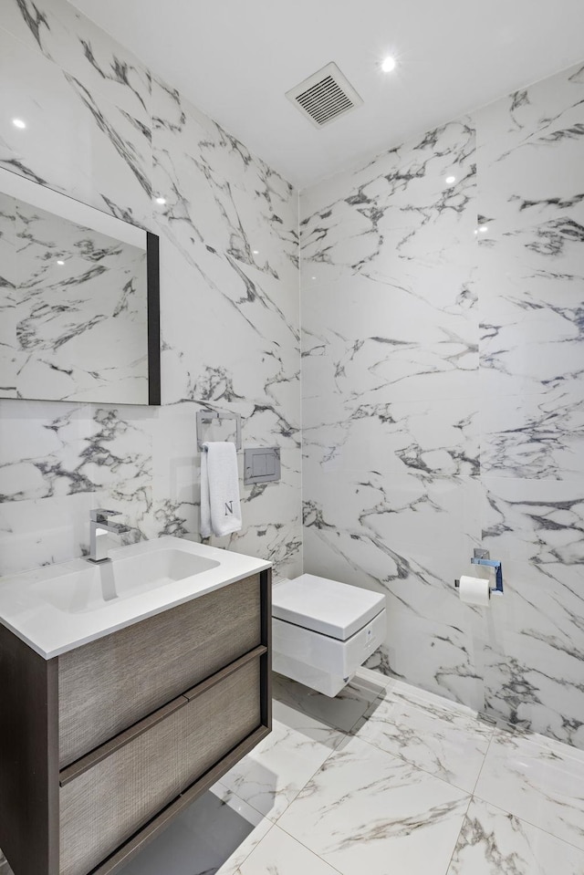 bathroom with visible vents, vanity, marble finish floor, toilet, and recessed lighting