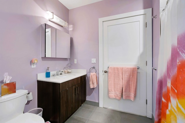 full bath with vanity, baseboards, tile patterned floors, and toilet