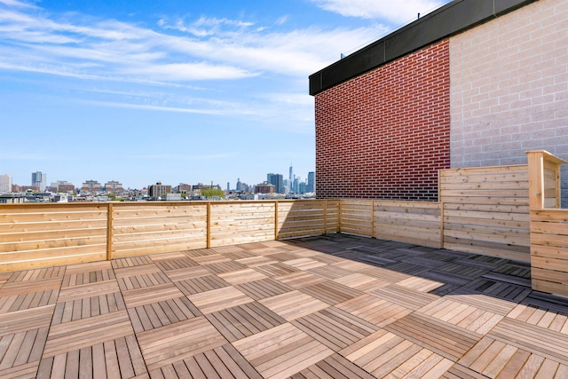 wooden terrace featuring a view of city