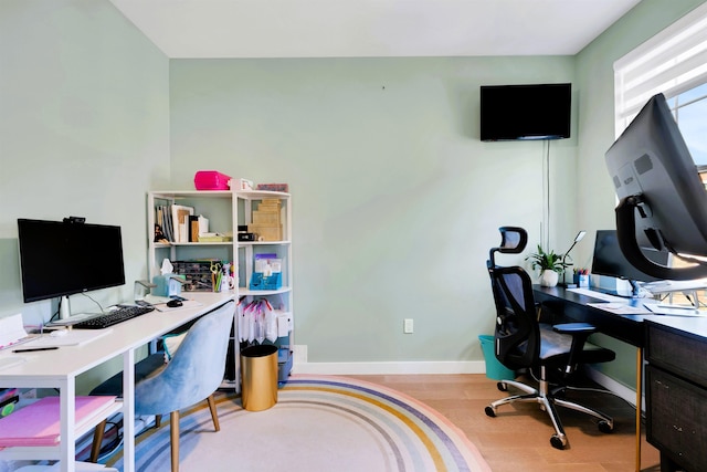 office area featuring baseboards and wood finished floors