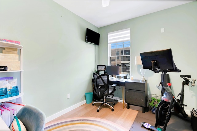 office featuring baseboards and wood finished floors