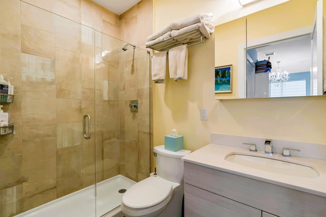 full bathroom featuring vanity, toilet, a chandelier, a shower stall, and visible vents