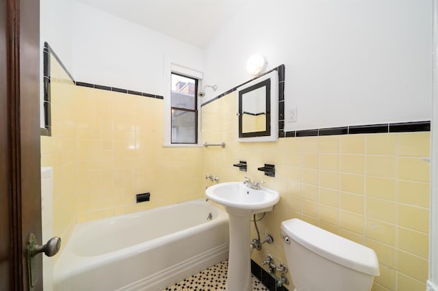 1100 83rd St Unit C1, North Bergen, NJ 07047 - bathroom with a tub to relax in, tile walls, and a wainscoted wall