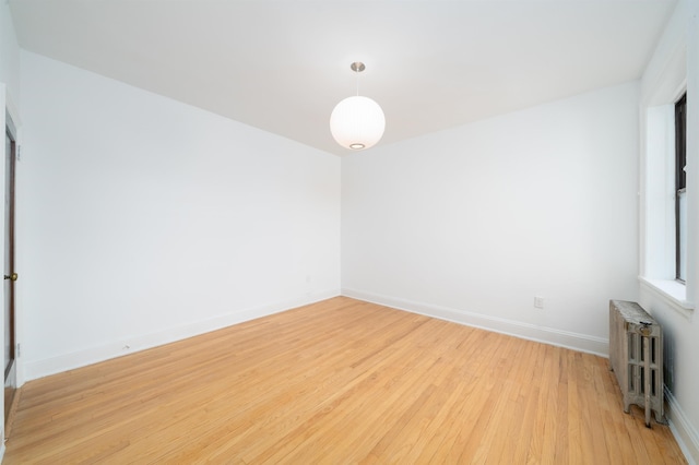 1100 83rd St Unit C1, North Bergen, NJ 07047 - empty room featuring radiator heating unit and light wood-style flooring