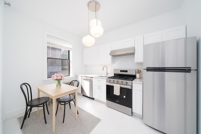 1100 83rd St Unit C1, North Bergen, NJ 07047 - kitchen with appliances with stainless steel finishes, wall chimney exhaust hood, light countertops, white cabinets, and hanging light fixtures
