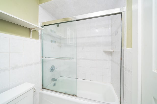 117 Clinton St Unit 2Fs, Hoboken, NJ 07030 - bathroom with tile walls, toilet, and shower / bath combination with glass door