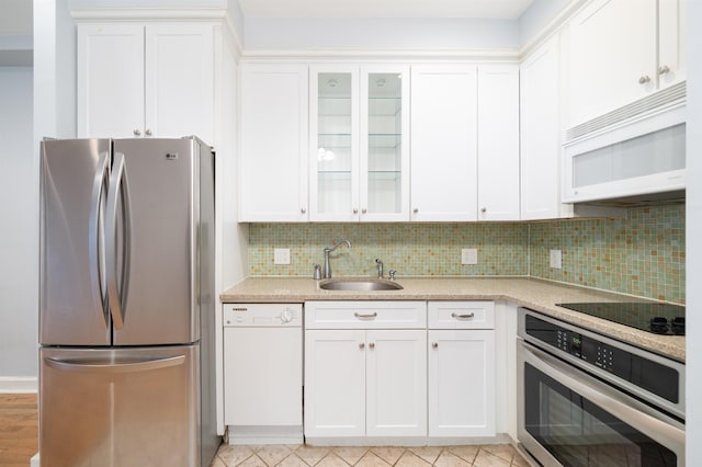 117 Clinton St Unit 2Fs, Hoboken, NJ 07030 - kitchen with appliances with stainless steel finishes, a sink, decorative backsplash, and white cabinetry