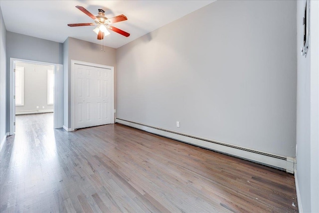 402 Grand St Unit 3S, Hoboken, NJ 07030 - unfurnished bedroom featuring a baseboard heating unit, wood finished floors, a closet, and ceiling fan