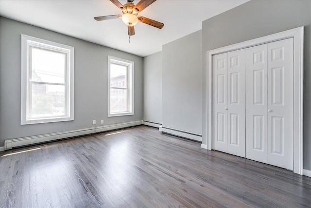 402 Grand St Unit 3S, Hoboken, NJ 07030 - unfurnished bedroom with wood finished floors, a baseboard heating unit, a ceiling fan, and a closet
