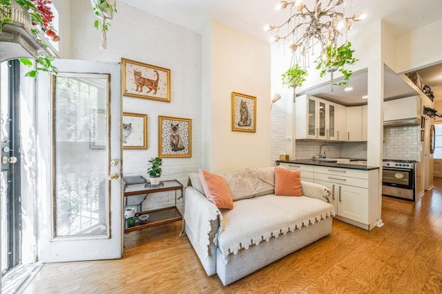 sitting room featuring a notable chandelier and light wood finished floors