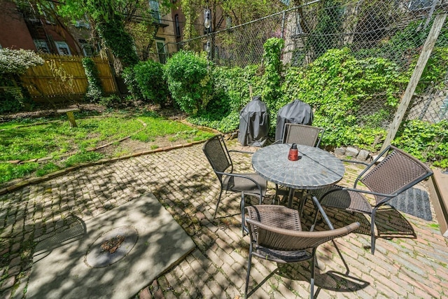 view of patio with fence and outdoor dining area