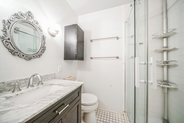 full bath with vanity, a stall shower, and toilet
