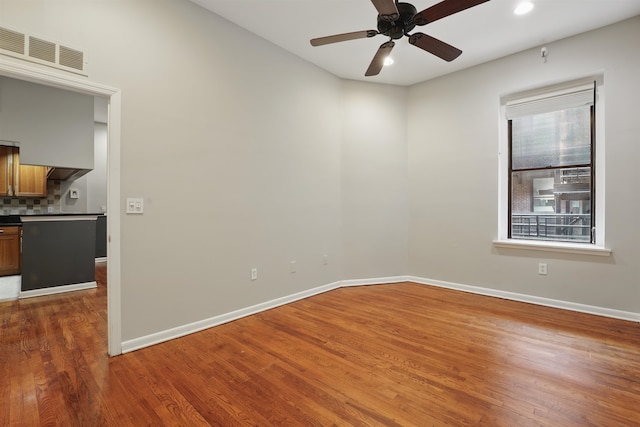 unfurnished room with a ceiling fan, baseboards, recessed lighting, wood finished floors, and visible vents
