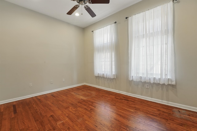 unfurnished room with baseboards, ceiling fan, and wood finished floors