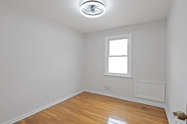 64 W 57th St, Bayonne, NJ 07002 - unfurnished room with light wood-type flooring and baseboards