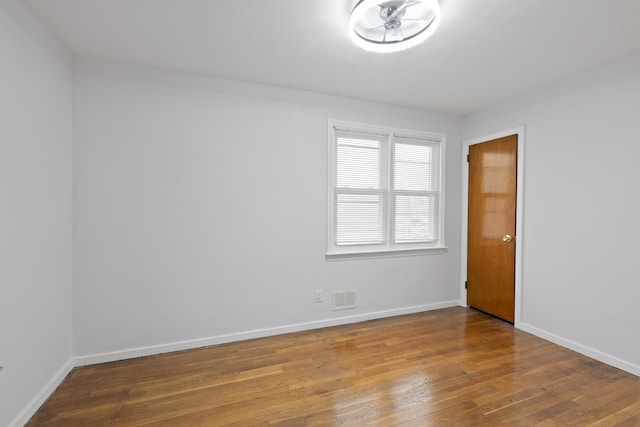 64 W 57th St, Bayonne, NJ 07002 - spare room featuring wood finished floors and baseboards