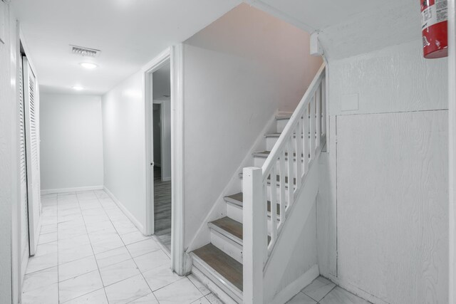64 W 57th St, Bayonne, NJ 07002 - stairway with marble look tile flooring