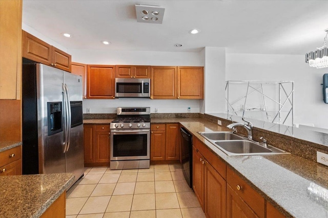 217 The Promenade Unit 217, Edgewater, NJ 07020 - kitchen featuring appliances with stainless steel finishes, a sink, brown cabinets, light tile patterned floors, and recessed lighting