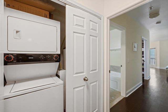 217 The Promenade Unit 217, Edgewater, NJ 07020 - laundry area with stacked washing machine and dryer, baseboards, and wood finished floors