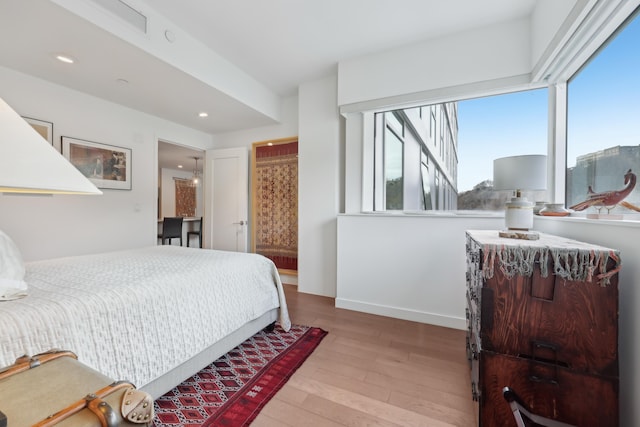 bedroom with recessed lighting, baseboards, and wood finished floors