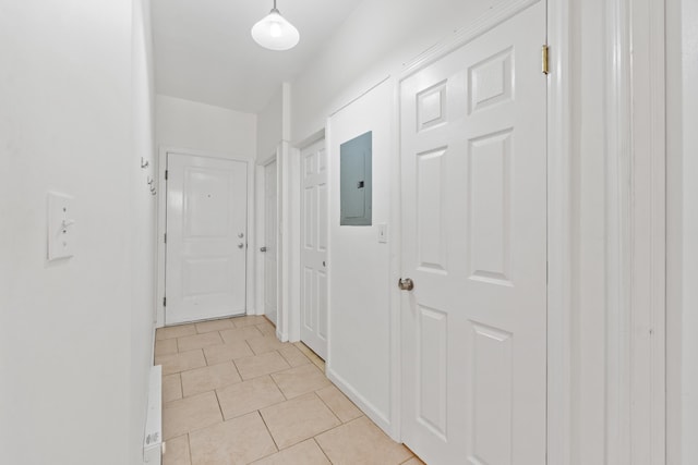 hallway featuring light tile patterned floors and electric panel