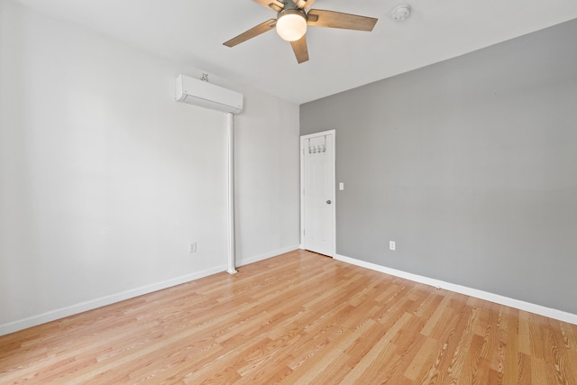 unfurnished room featuring ceiling fan, light hardwood / wood-style floors, and a wall unit AC