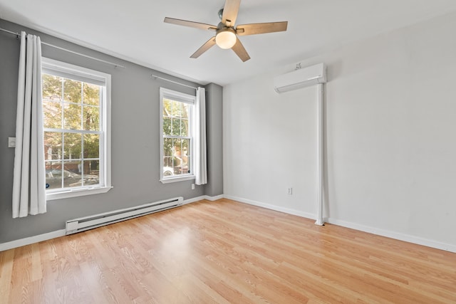 unfurnished room featuring a baseboard heating unit, ceiling fan, a wall unit AC, and light hardwood / wood-style flooring