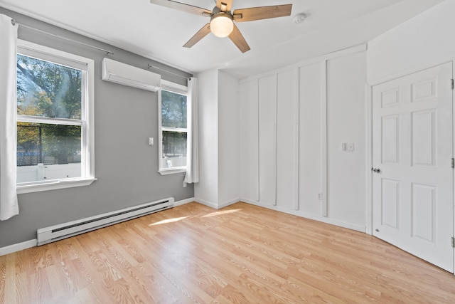 spare room featuring ceiling fan, a healthy amount of sunlight, a wall unit AC, and a baseboard radiator