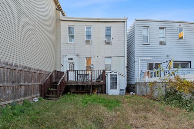 back of property with cooling unit and a deck