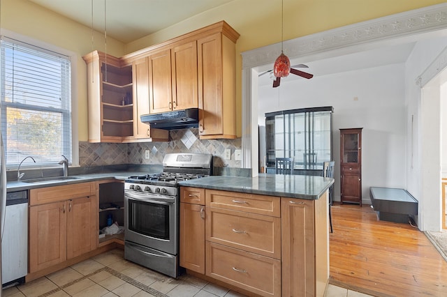 kitchen featuring ceiling fan, sink, stainless steel appliances, tasteful backsplash, and decorative light fixtures