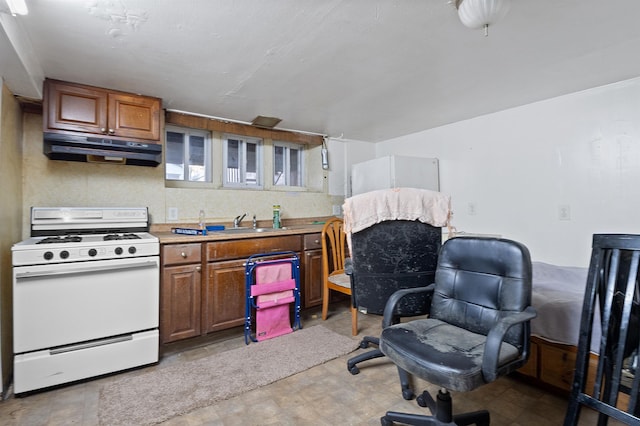 kitchen featuring white range oven and sink