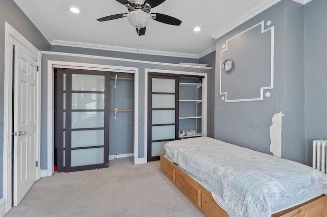 bedroom featuring ceiling fan, light colored carpet, and ornamental molding