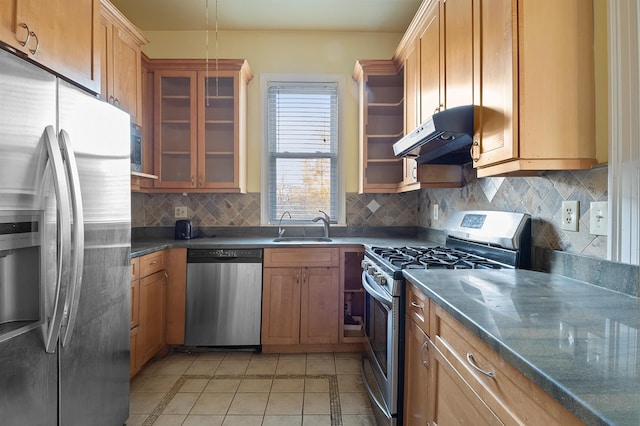 kitchen featuring light tile patterned floors, stainless steel appliances, tasteful backsplash, and sink