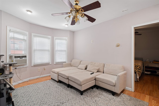 living room featuring ceiling fan, hardwood / wood-style floors, and cooling unit