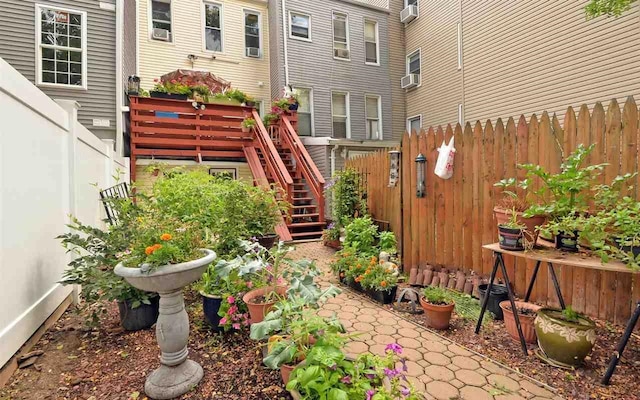 view of yard with stairway, cooling unit, and fence