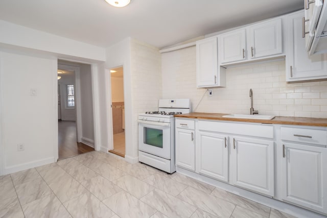 kitchen featuring a sink, wood counters, white gas range, and white cabinets