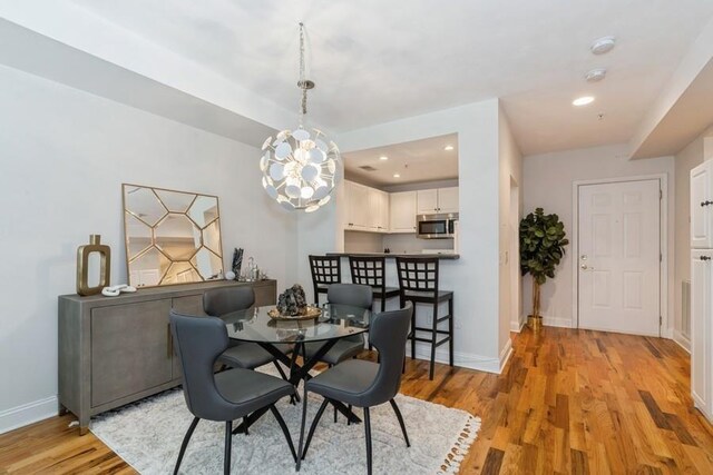 dining area featuring recessed lighting, baseboards, and light wood-type flooring