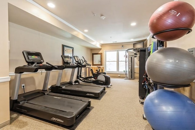 exercise room with recessed lighting, ornamental molding, and carpet flooring