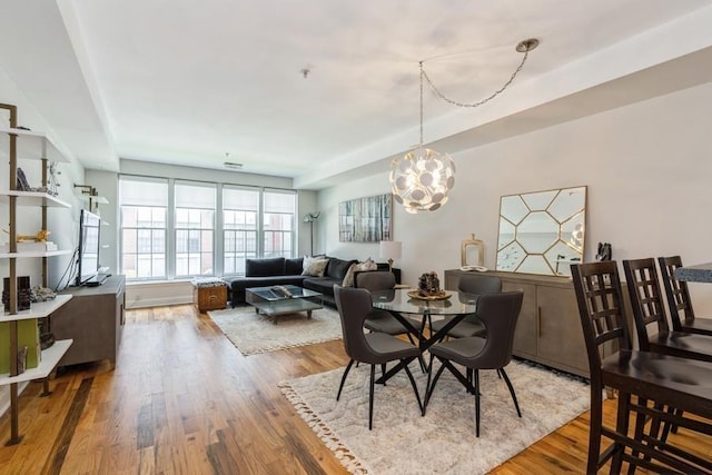 dining room featuring a notable chandelier and wood finished floors