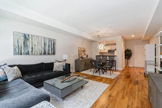 living room featuring light wood finished floors and baseboards